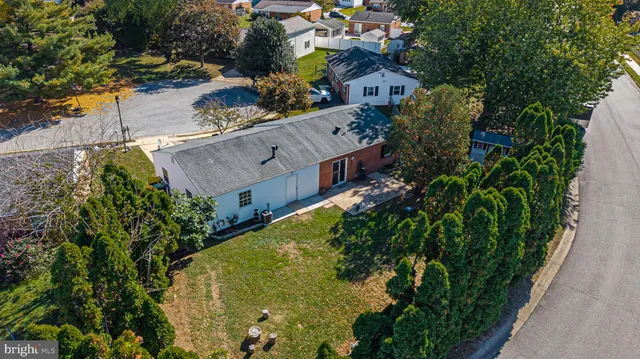 an aerial view of a house with a yard and garden