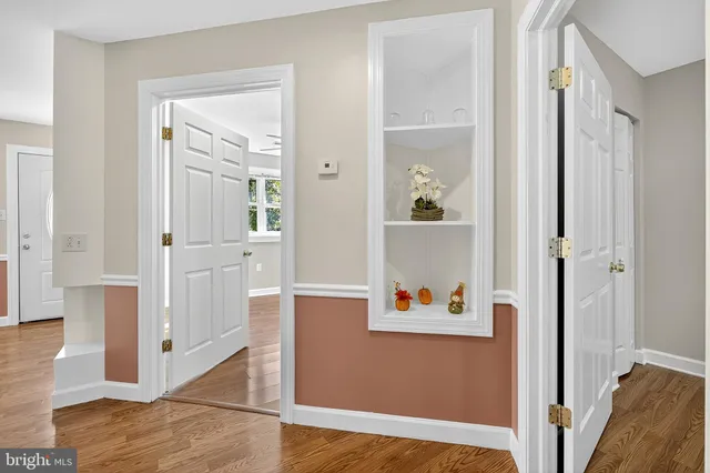wooden floor with white walls and windows