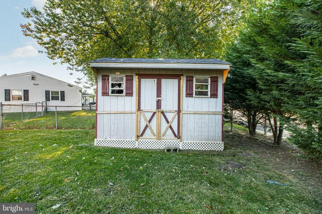 a view of backyard of house with green space