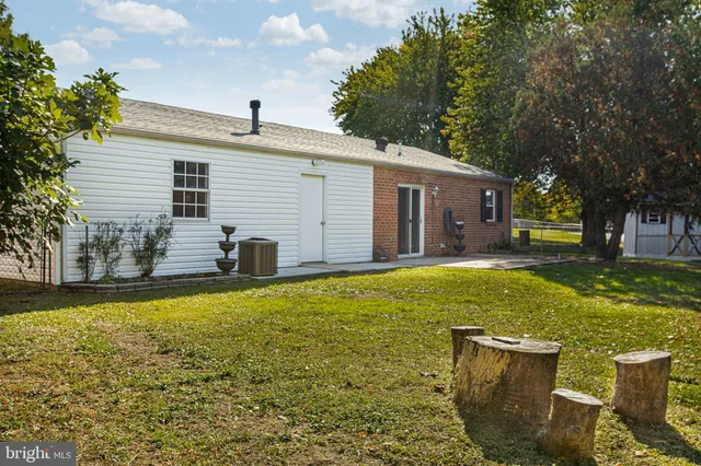 a backyard of a house with yard and outdoor seating