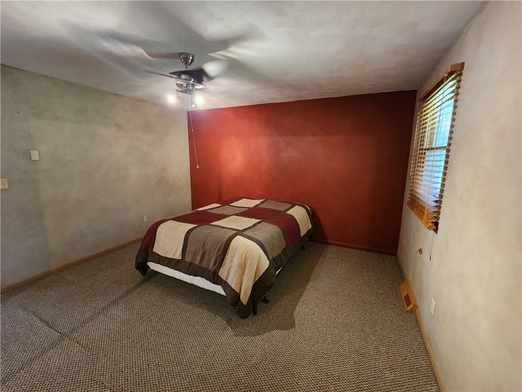 1047 Kettering Road Creekside, PA 15732 - Photo 9 of 24 a bedroom with a bed and a ceiling fan
