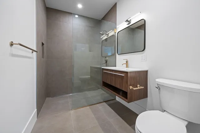 a bathroom with a toilet sink and mirror