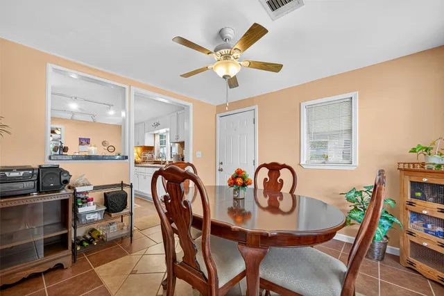 a dining room with furniture and window