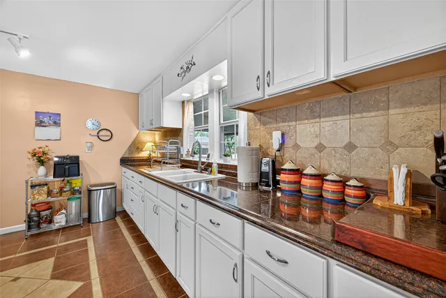 a kitchen with stainless steel appliances granite countertop a sink and cabinets