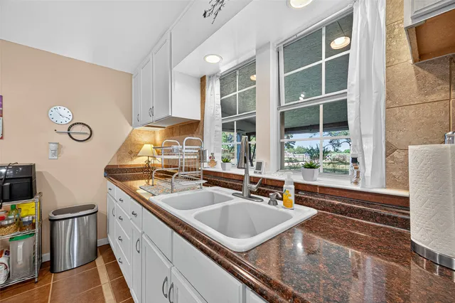 a kitchen with a sink and a stove top oven