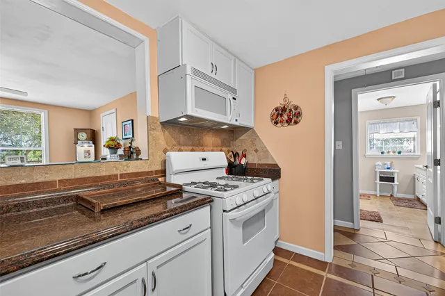 a kitchen with granite countertop a stove and a sink