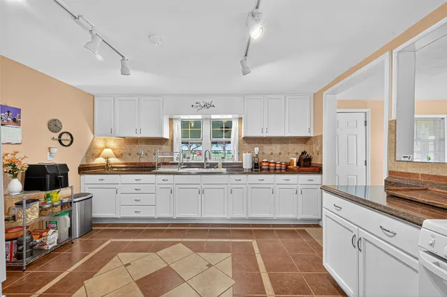 a kitchen with stainless steel appliances granite countertop a sink and cabinets