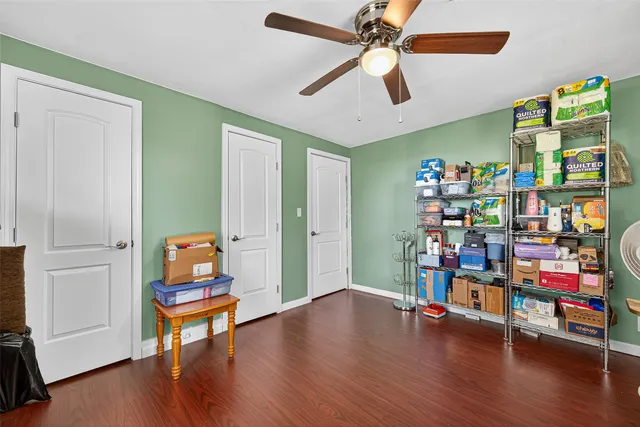 a living room with lots of furniture and a wooden floor