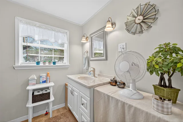 a bathroom with a sink a mirror and a window