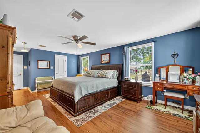 a bed room with a bed and a chair