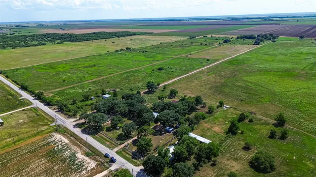 a view of a field with an ocean view