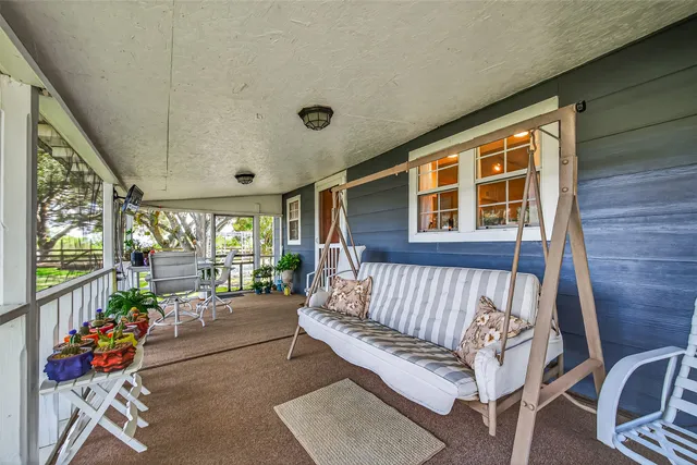 a view of a patio with couches and potted plants
