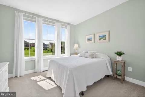 a spacious bedroom with a large bed and a window