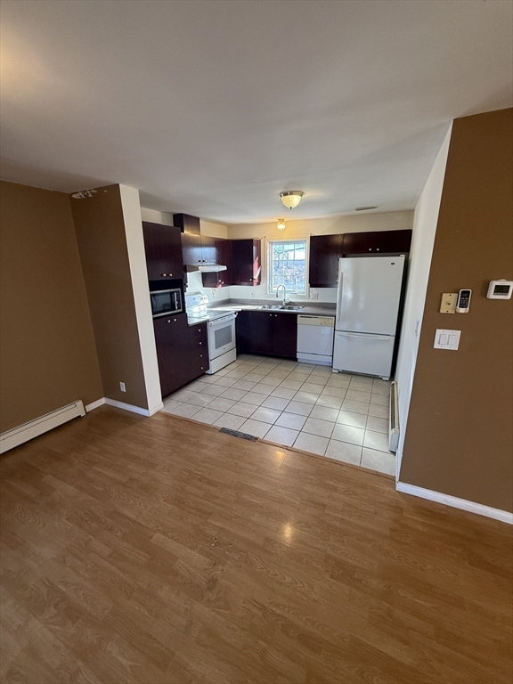 51 Forest Street, Unit 1 Lawrence, MA 01841 - Photo 3 of 8 a view of a kitchen with a sink and a refrigerator