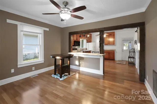 a view of kitchen with livingroom and hardwood floor
