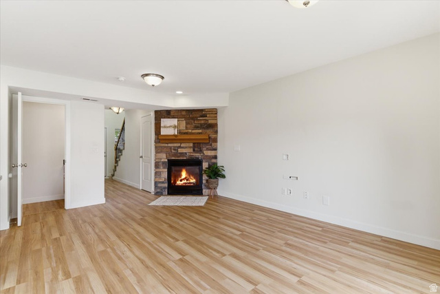 2082 Evans Cove Loop Layton, UT 84041 - Photo 4 of 25 Wood look flooring in family room with stone fireplace