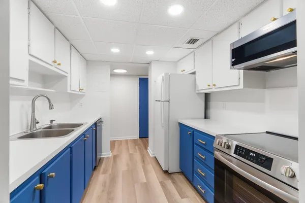 a kitchen with stainless steel appliances granite countertop a sink a stove and a refrigerator