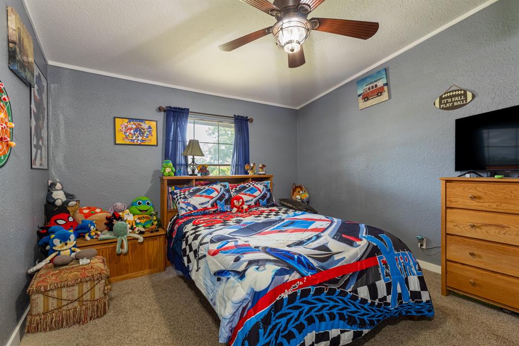 75 Southern Road Mineral Wells, TX 76067 - Photo 24 of 31 a bedroom with a bed and a chandelier