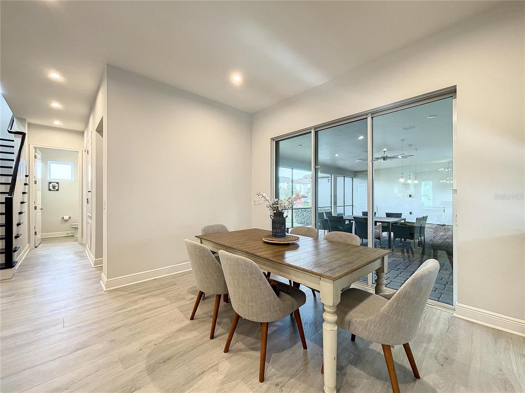 9062 Sperry Street Orlando, FL 32827 - Photo 13 of 44 a view of a dining room with furniture and wooden floor