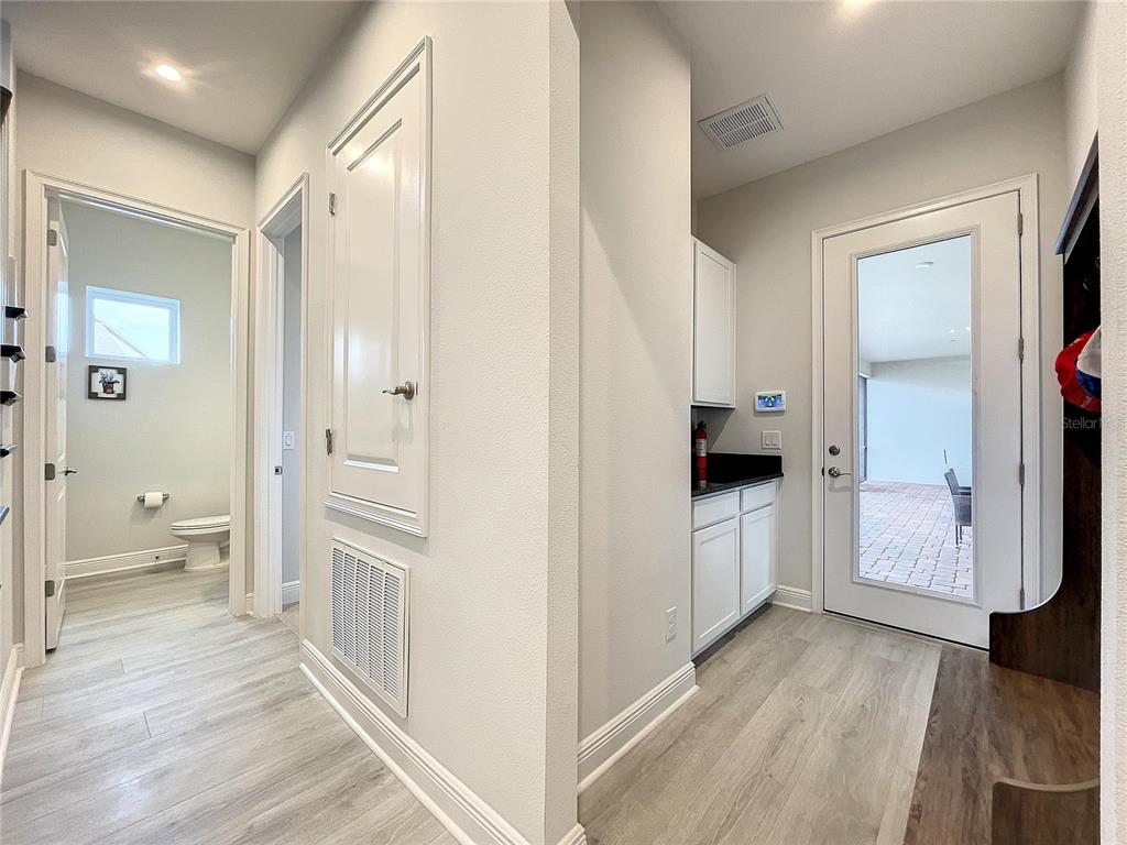 9062 Sperry Street Orlando, FL 32827 - Photo 16 of 44 a view of a bathroom with a walk in closet and wooden floor