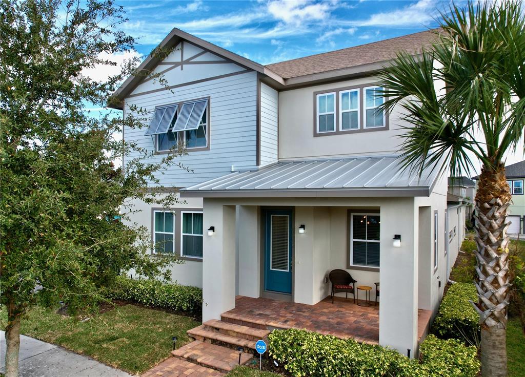 9062 Sperry Street Orlando, FL 32827 - Photo 2 of 44 a view of a white house with a large window and potted plants