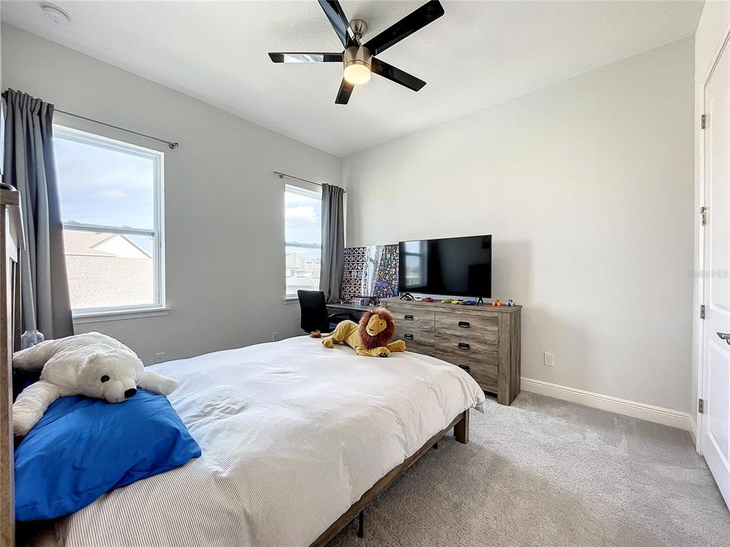 9062 Sperry Street Orlando, FL 32827 - Photo 30 of 44 a bedroom with a bed and window