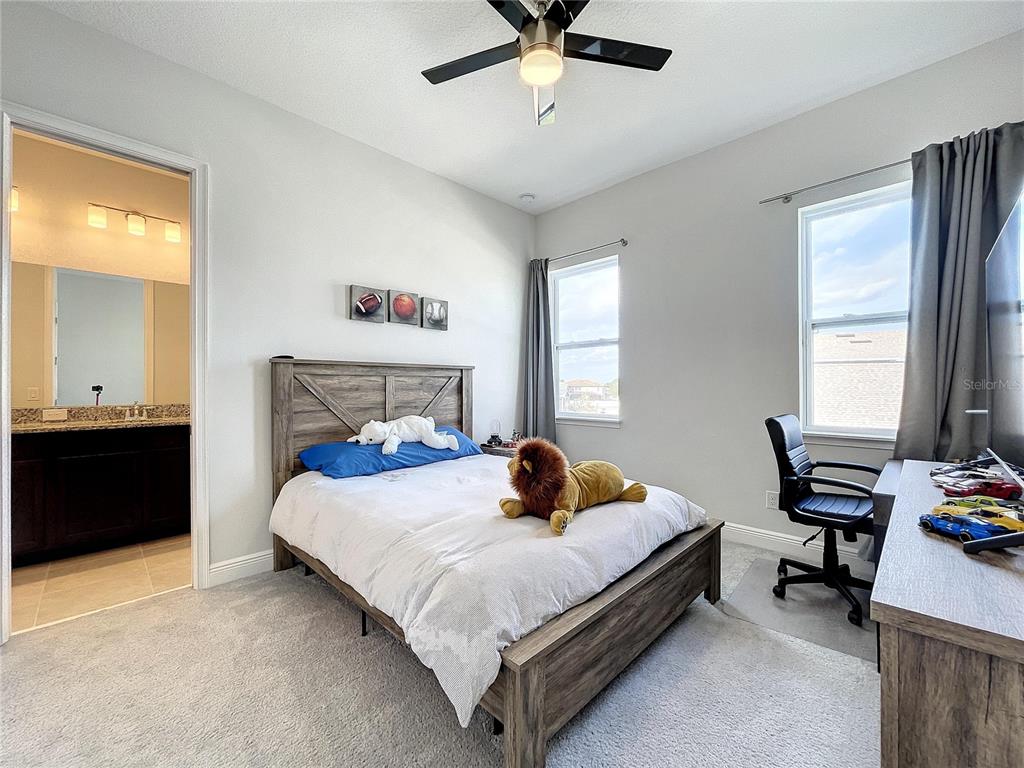 9062 Sperry Street Orlando, FL 32827 - Photo 31 of 44 a bedroom with a bed and a window