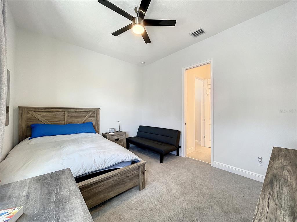 9062 Sperry Street Orlando, FL 32827 - Photo 33 of 44 a bedroom with a bed and a window