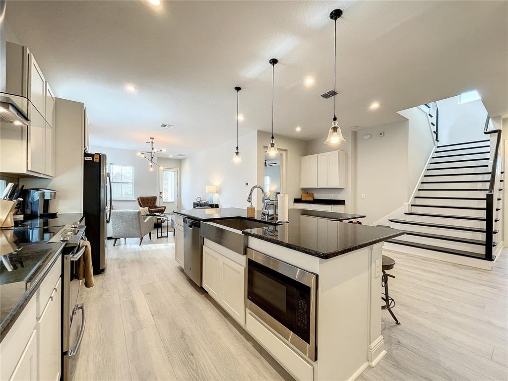 9062 Sperry Street Orlando, FL 32827 - Photo 10 of 44 a kitchen with stainless steel appliances kitchen island a large island in the center