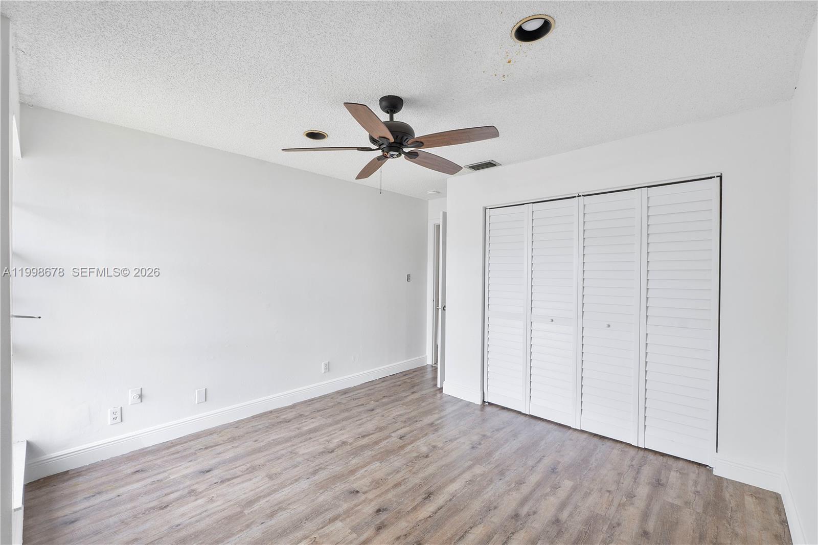 8243 Northwest 9th Street, Unit 7 Plantation, FL 33324 - Photo 11 of 30 a view of an empty room with wooden floor