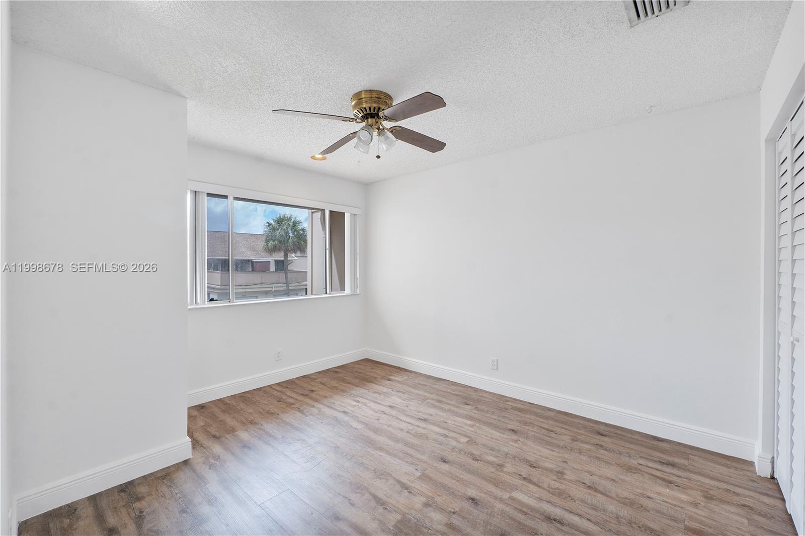 8243 Northwest 9th Street, Unit 7 Plantation, FL 33324 - Photo 12 of 30 a view of a room with wooden floor and fan