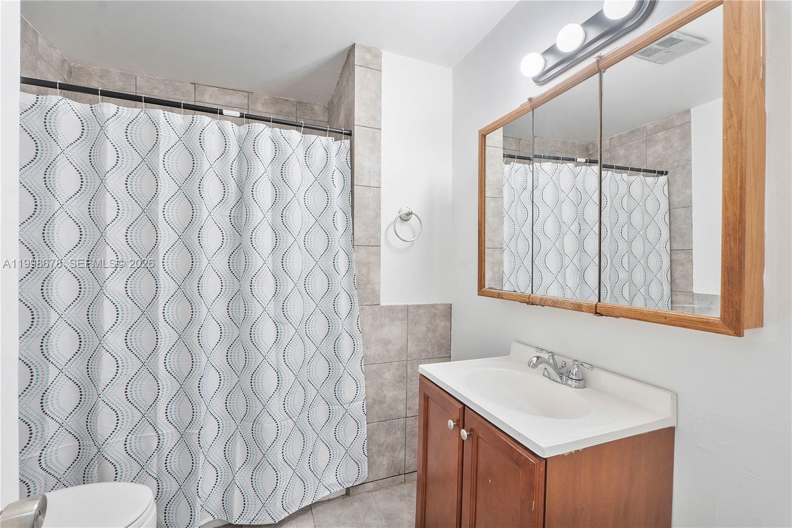 8243 Northwest 9th Street, Unit 7 Plantation, FL 33324 - Photo 14 of 30 a bathroom with a sink and a mirror