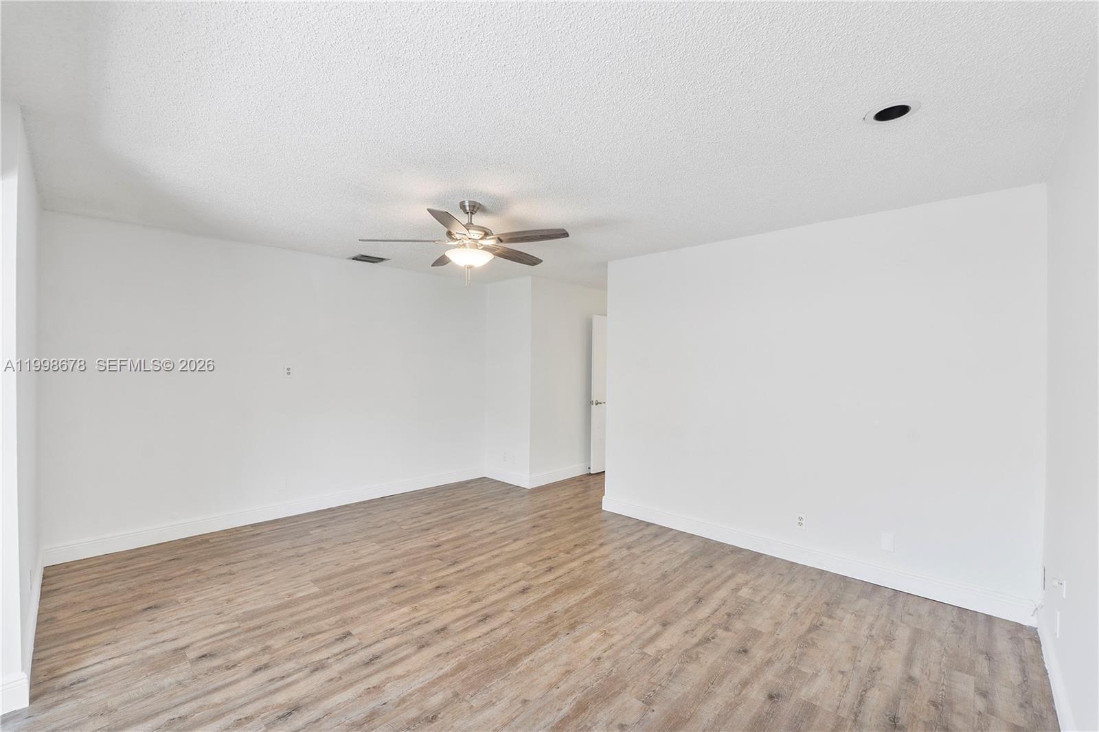 8243 Northwest 9th Street, Unit 7 Plantation, FL 33324 - Photo 15 of 30 a view of an empty room with wooden floor