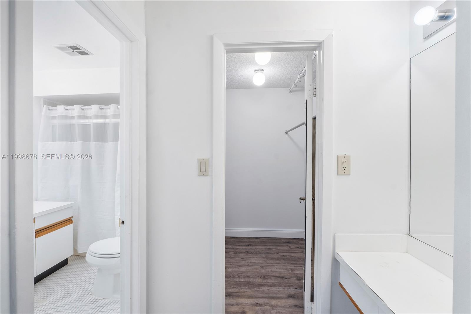 8243 Northwest 9th Street, Unit 7 Plantation, FL 33324 - Photo 18 of 30 a bathroom with a granite countertop bathtub shower and toilet