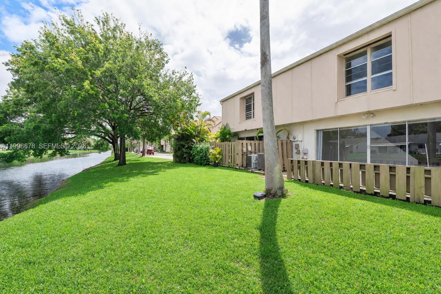 8243 Northwest 9th Street, Unit 7 Plantation, FL 33324 - Photo 24 of 30 a house with green field in front of it