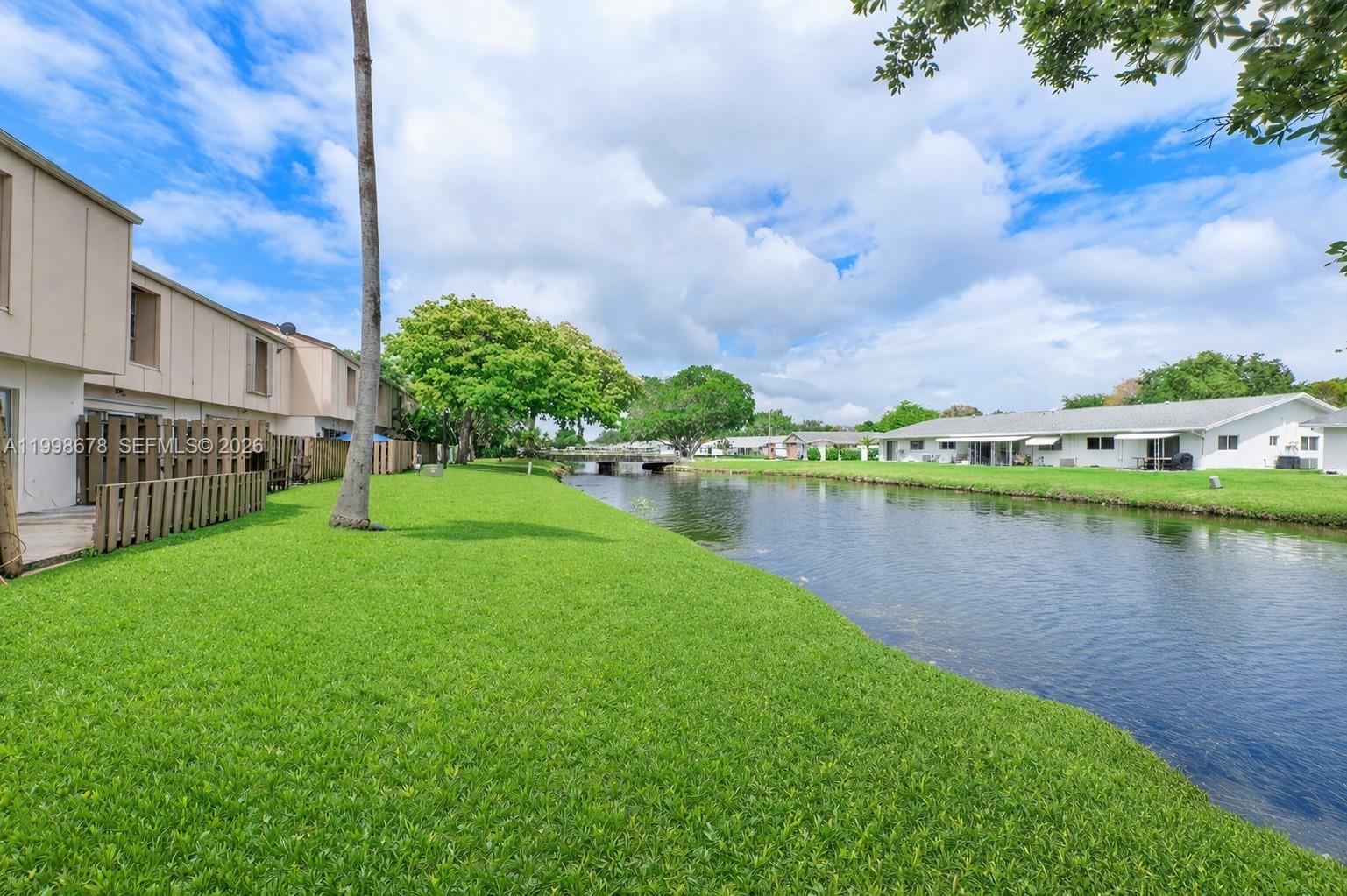 8243 Northwest 9th Street, Unit 7 Plantation, FL 33324 - Photo 25 of 30 a view of a lake with houses in the back