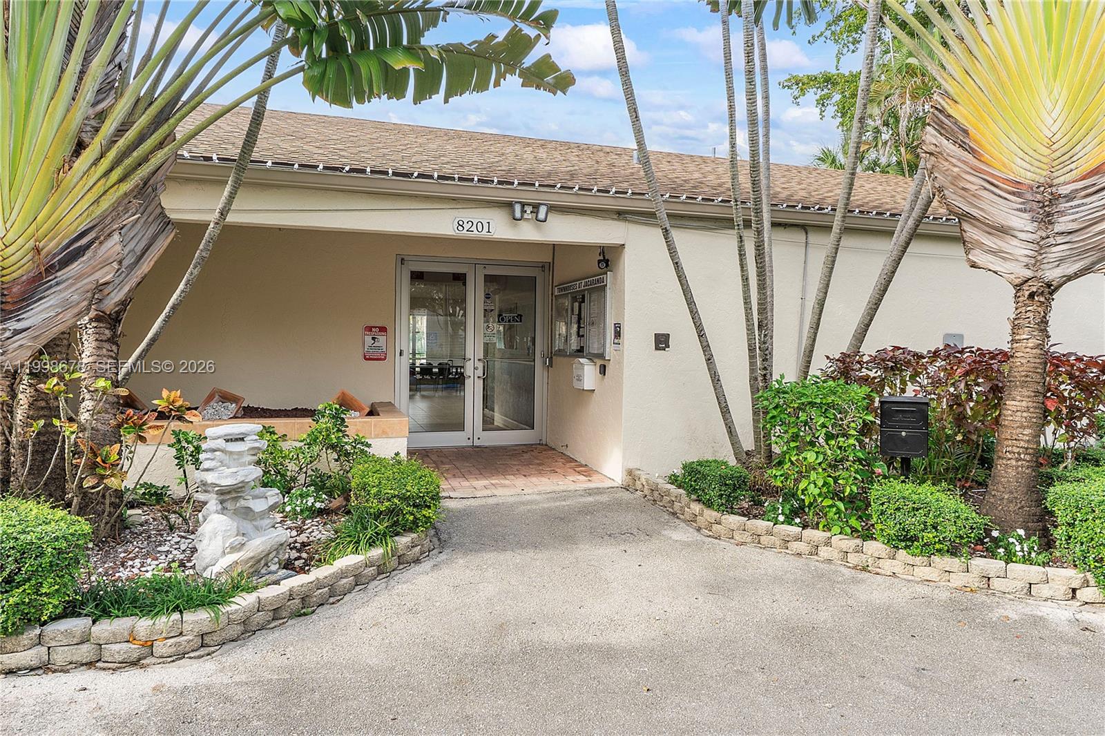 8243 Northwest 9th Street, Unit 7 Plantation, FL 33324 - Photo 26 of 30 a front view of a house with a garden