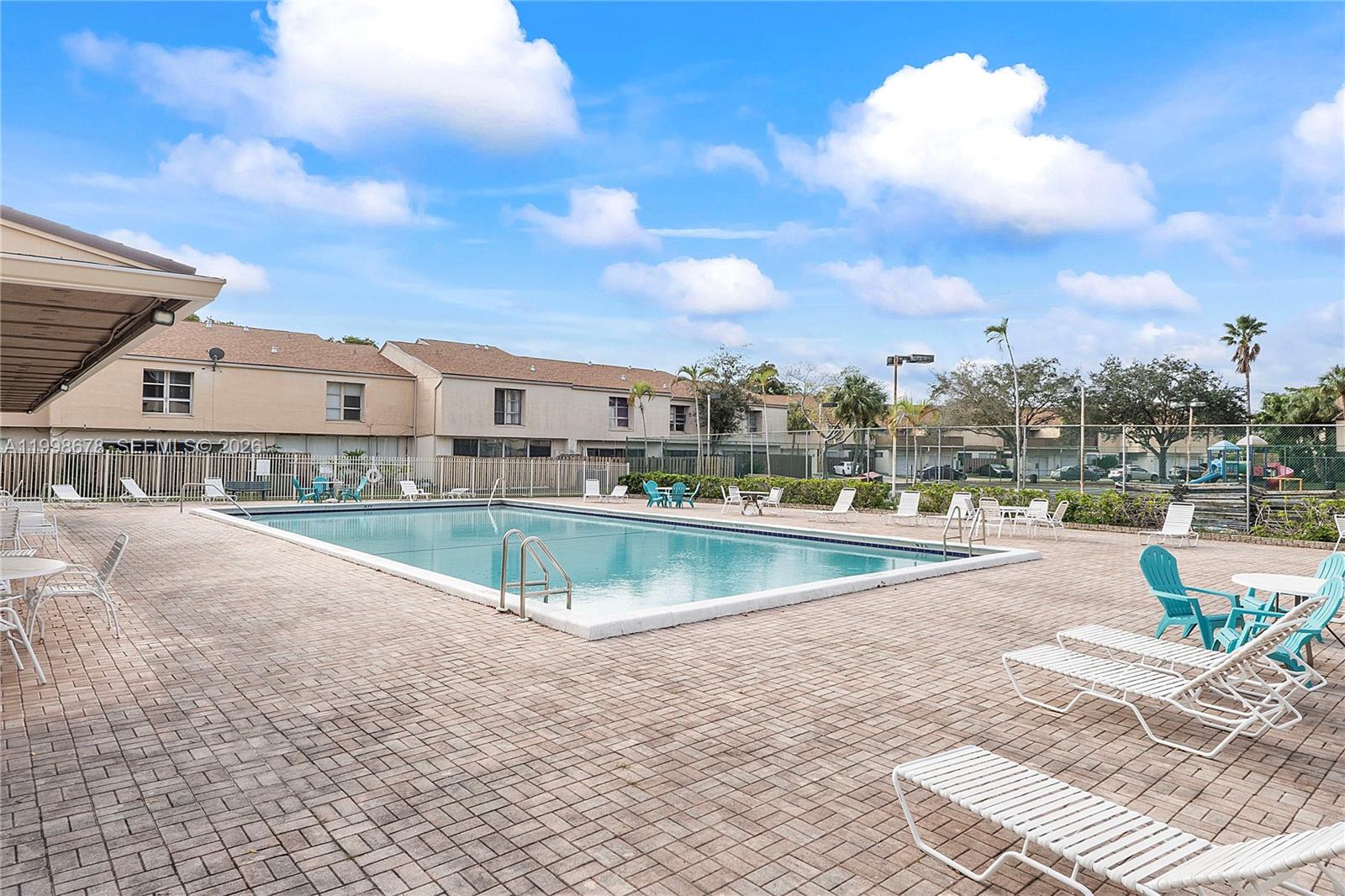 8243 Northwest 9th Street, Unit 7 Plantation, FL 33324 - Photo 28 of 30 a view of a swimming pool with a lounge chair