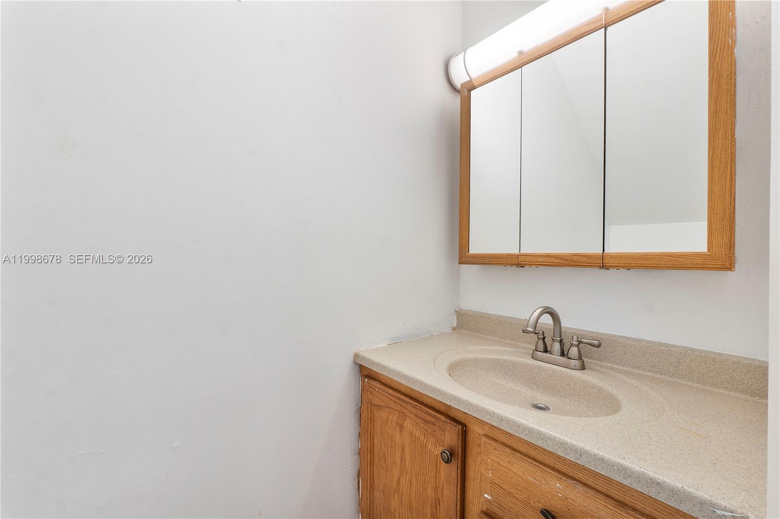 8243 Northwest 9th Street, Unit 7 Plantation, FL 33324 - Photo 6 of 30 a bathroom with a sink and a mirror