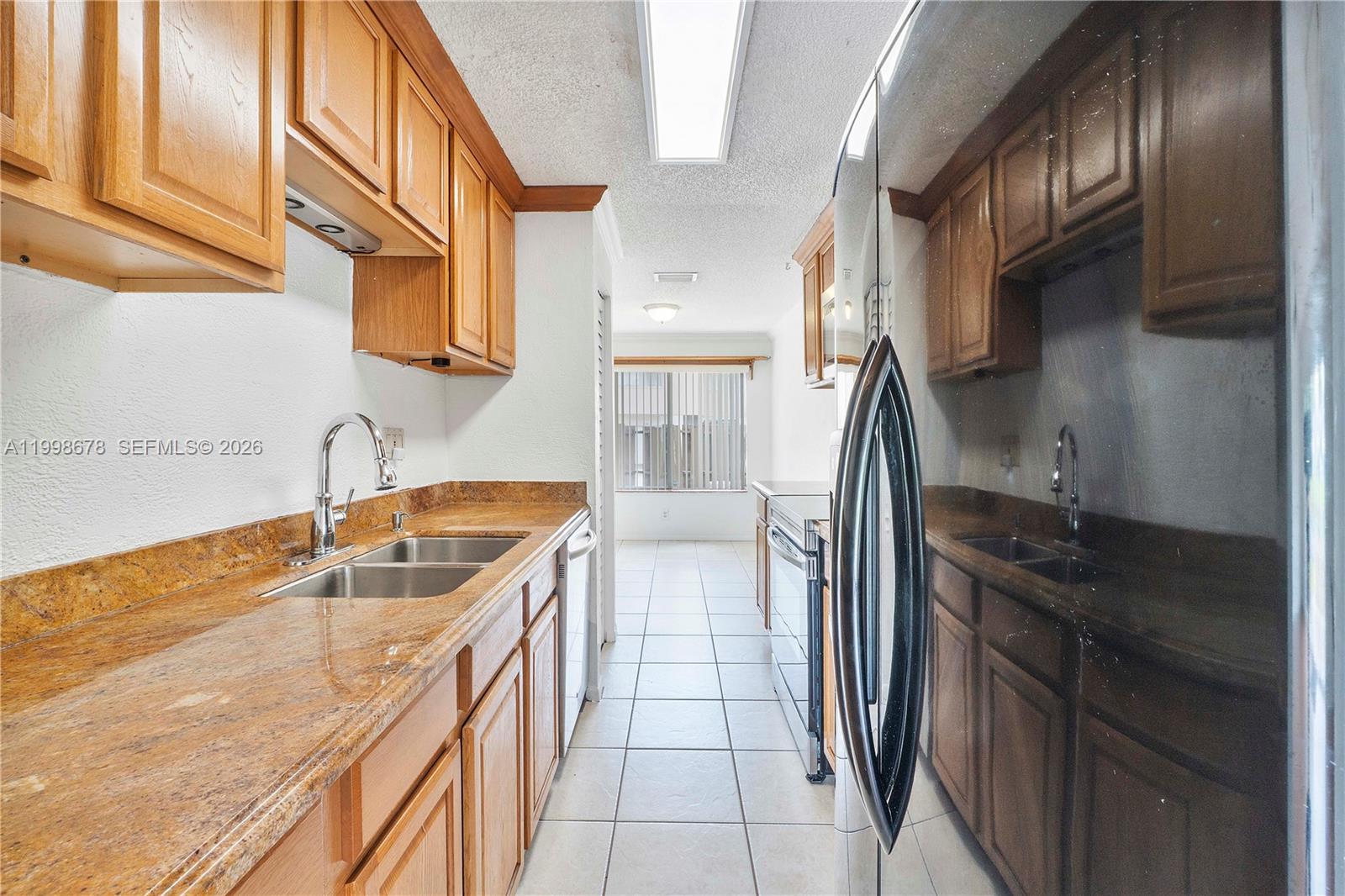 8243 Northwest 9th Street, Unit 7 Plantation, FL 33324 - Photo 7 of 30 a kitchen with a sink stove and refrigerator