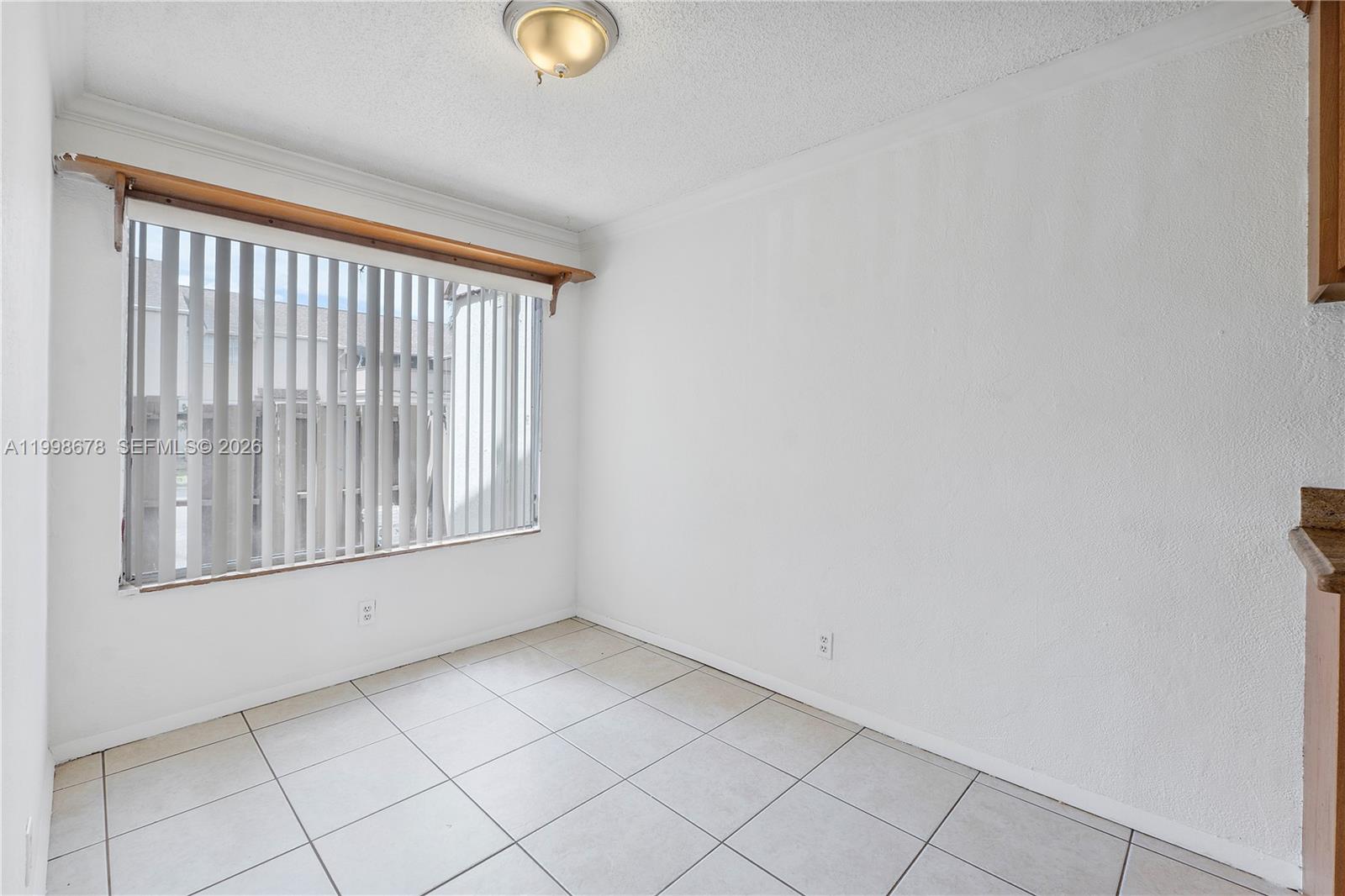 8243 Northwest 9th Street, Unit 7 Plantation, FL 33324 - Photo 9 of 30 an empty room with windows