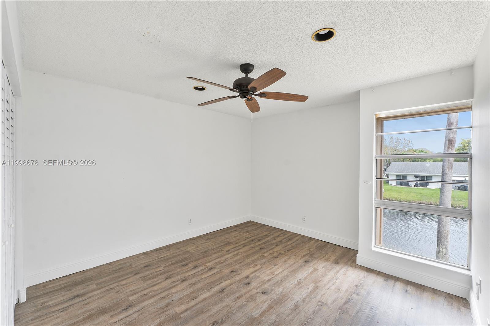 8243 Northwest 9th Street, Unit 7 Plantation, FL 33324 - Photo 10 of 30 wooden floor in an empty room with a window