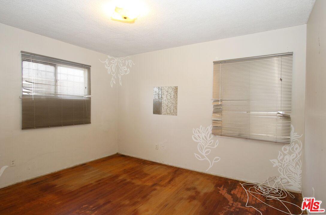 1022 West 156th Street Compton, CA 90220 - Photo 12 of 24 a view of empty room with wooden floor and fan