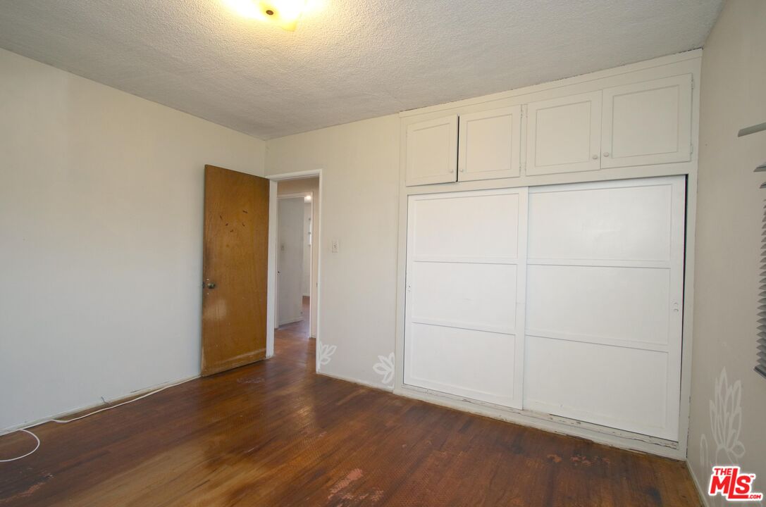 1022 West 156th Street Compton, CA 90220 - Photo 13 of 24 an empty room with wooden floor
