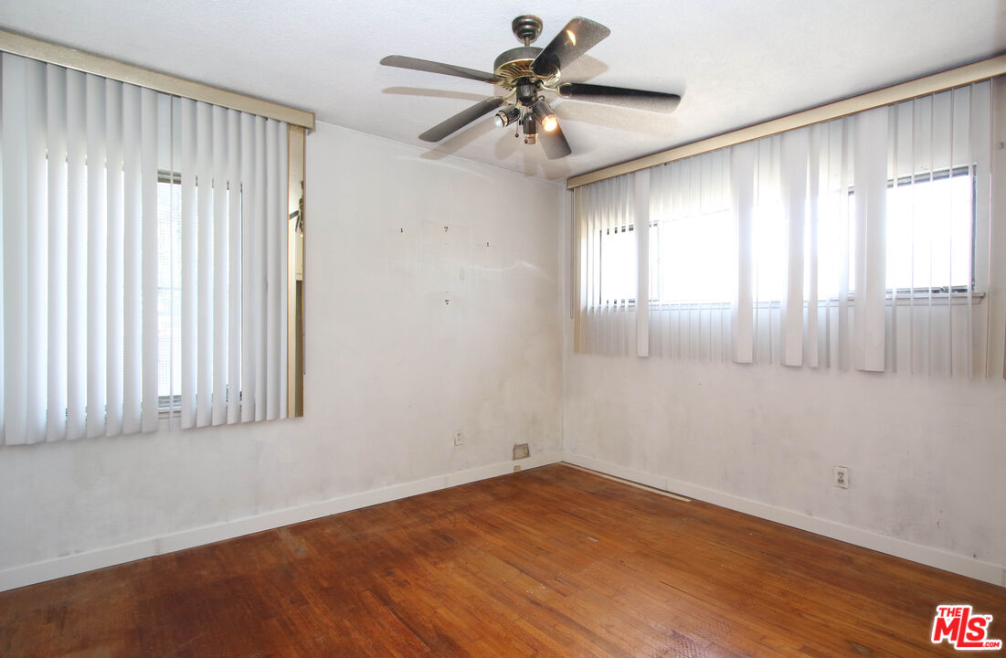 1022 West 156th Street Compton, CA 90220 - Photo 14 of 24 wooden floor in an empty room with a window