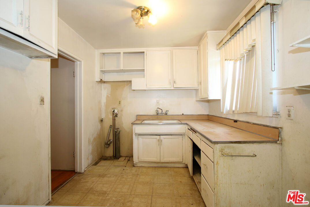 1022 West 156th Street Compton, CA 90220 - Photo 17 of 24 a kitchen with stainless steel appliances granite countertop a sink stove and refrigerator