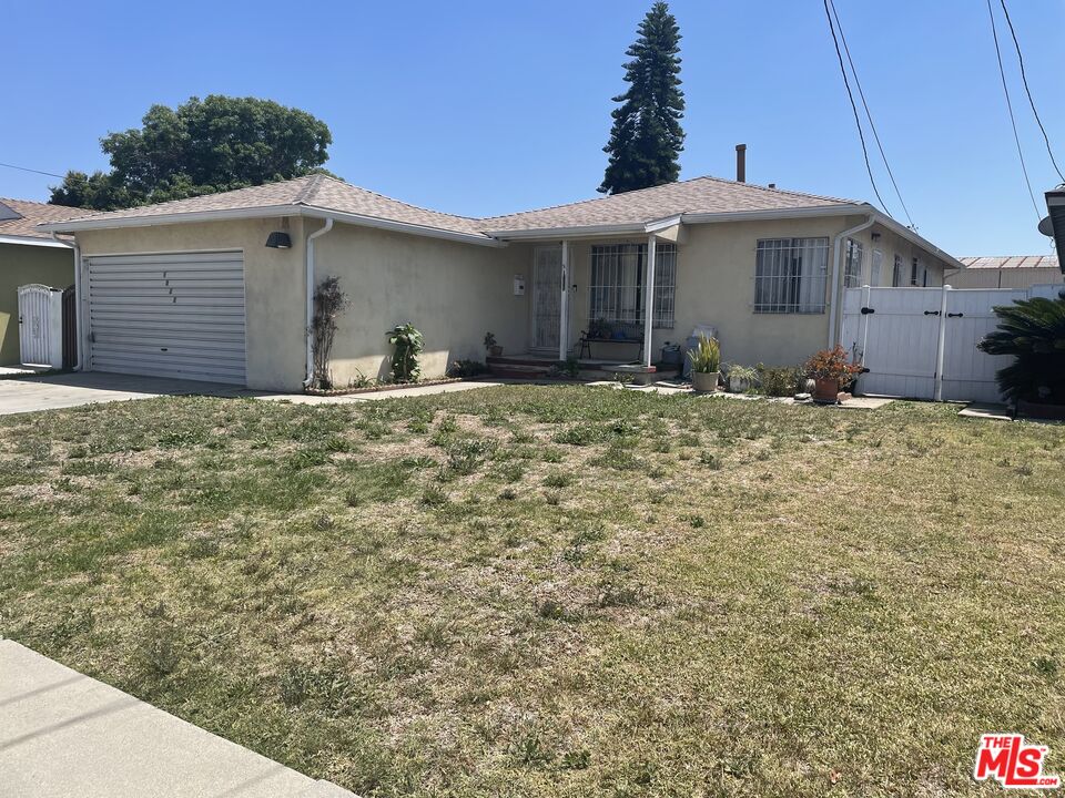 1022 West 156th Street Compton, CA 90220 - Photo 2 of 24 a front view of a house with a yard