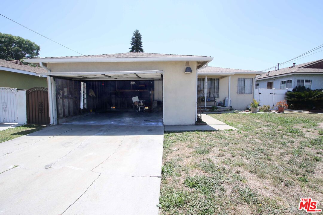 1022 West 156th Street Compton, CA 90220 - Photo 3 of 24 a view of a house with a porch and a yard