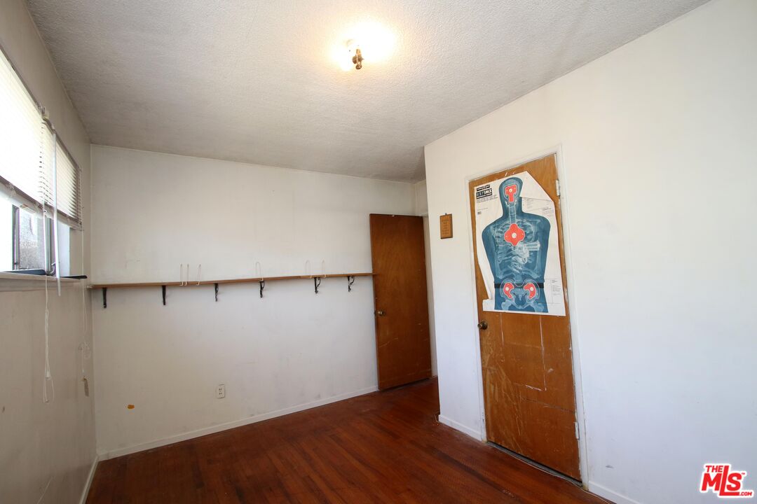 1022 West 156th Street Compton, CA 90220 - Photo 8 of 24 an empty room with wooden floor