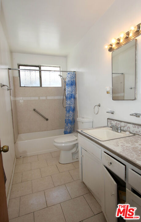 1022 West 156th Street Compton, CA 90220 - Photo 10 of 24 a bathroom with a sink a toilet and shower